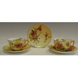 Two Royal Worcester cabinet cups and saucers,