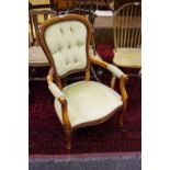 A reproduction open armchair, button upholstered back, padded seat,