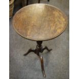 A George III and later oak tripod table, circular top, baluster column, cabriole legs.