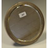 A George V silver circular easel dressing table mirror, bevelled plate,