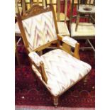 A Victorian mahogany armchair, carved cresting top rail, padded back, arms and seat,