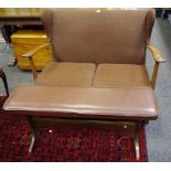 A 1940's cottage wingback two seat sofa, oak frame; a long footstool.