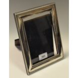 A Harrods of London rectangular silver easel photograph frame with beaded border, Sheffield 1995.