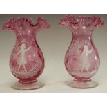 A near pair of Mary Gregory flared cylindrical cranberry glass vases decorated with young girl in