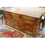 An oak Bevan Funell sideboard, moulded oversailing top, three drawers over three door cupboard.