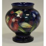 A Moorcroft pottery Orchid pattern squat vase, blue ground, 8.