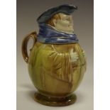 A Novelty Majolica ale Toby jug, modelled as portly gentleman, with Robe, scarf and hat,