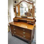 An Edwardian mahogany dressing table, shaped bevel edged mirror,