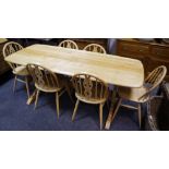 An Ercol stripped oak refectory style table,