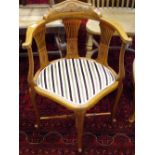 A late Victorian corner chair, shaped and carved top rail, pierced splats, padded seat,