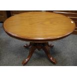 A Victorian mahogany loo table, oval top, deep frieze, four turned columns.