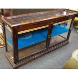 A Victorian mahogany shop display counter, later shelves 175cm x 91cm x 48.