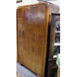 A 1940's walnut veneered bedroom suite comprising double wardrobe tallboy and dressing chest (3)