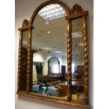 A decorative contemporary arched mirror, foxed panels,