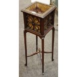 An Edwardian jardiniere stand, fretworked sides, metal liner, tapering legs,