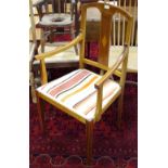 An Edwardian mahogany open arm chair, arched top rail, outswept arms, padded seat,