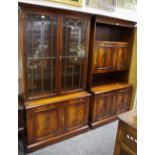 A Reprodux flame mahogany bookcase cabinet, two astragal glazed doors to top,