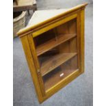 A small oak and pine wall mounded corner cupboard,