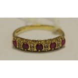A lady's nine stone ruby and diamond ring, 9ct gold shank.
