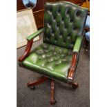 A modern button upholstered green leather office swivel chair