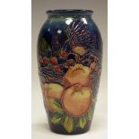 A Moorcroft Finches pattern tapering vase, tube lined with birds perched amongst ripe fruit,