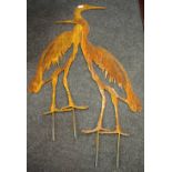 A pair of oxidized steel heron cut outs.