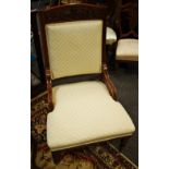 A Victorian mahogany nursing chair, carved top rail, padded back, fluted arms, padded seat.
