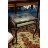 A mahogany bijouterie table, hinged cover, felt lined base, cabriole legs, club feet.