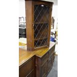 An oak wall mounted corner cabinet,