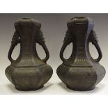 A pair of Eastern basalt vases mythical beast terminating handles