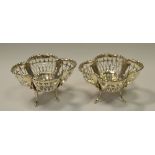 A pair of pierced quatrefoil silver bonbon dishes raised on four legs, Birmingham 1910.