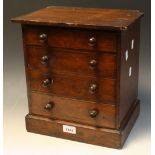 A miniature Victorian stained pine chest of four graduated drawers the top two fitted for