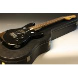 An Encore electric guitar, black body; an Epiphone acoustic parlour guitar,