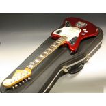 A Fender Jaguar guitar, red body, mother of pearl block inlaid fret board,