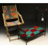 A Victorian style wrought iron dolls bed frame with hinged canopy;
