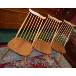 A set of three Ercol dining/side chairs, each with a shaped cresting rail, stick back, saddle seat,