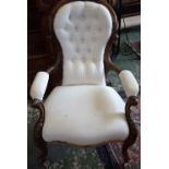 A Victorian spoon back open armchair,