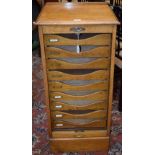 An early-mid 20th century oak tambour front filing cabinet,