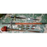 A decorative wooden sheath sword; another similar replica sword;