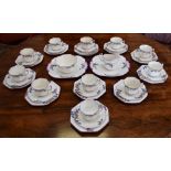 An Art Deco hand painted part tea service, comprising eleven cups, saucers and side plates,