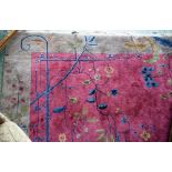 A woollen carpet, in tones of plum, blue and green,