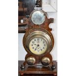 A late 19th/early 20th century bell clock, mirror top, above circular dial,