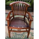 A mahogany elbow chair, curved cresting rail, bowed arm rails terminating in scroll hand rests,