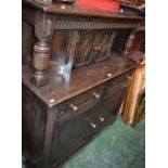 An oak court cupboard, rectangular top above a nulled frieze and a pair of small doors,
