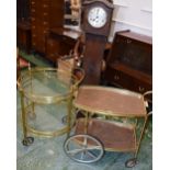A retro mid-20th century two tier buffet/serving trolley; another; an oak cased longcase clock,