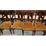 A set of four Edwardian mahogany side chairs, each with an arched cresting rail, pierced splat,