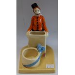 A novelty ceramic cigarette and match holder, as an usher standing,