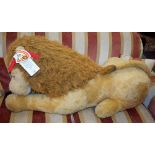 A large plush resting lion toy, by B.G.