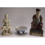 A Chinese blanc de chine figure, of a deity, seated in meditation holding a sphere,