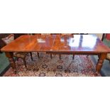 A late Victorian/Edwardian mahogany extending dining table, chamfered rectangular top,